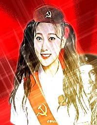 image description: a person with pigtails smiles widely at the camera, edited to have a sash and hat emblazened with a hammer and sickle, the symbol of communism. there is a person grinning even widely behind her, in front of a red background. end image description.